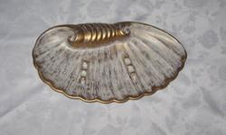 FOR SALE - ROYAL HAEGER ASHTRAY IN GOLD BRUSH TONE, ON THE BACK IN RAISED PRINT READING ROYAL HAEGER #180.  IT IS IN EXCELLENT CONDITION, AND MEASURES 12" LONG  x  6" WIDE, AND IS IN THE SHAPE OF A SEA SHELL.