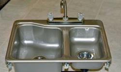RV Sink, plastic, 60/40, stainless steel colour. 
Sizes: 25? X 19?, left bowl approx. 12.5? X 15? X 6.5? right bowl approx. 8? X 13? X 5?,  Good condition, came with trailer June 2009, very little use.   Includes sink, tap set, drain baskets, traps and