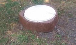 Tree stump shaped sandbox or pool with cover.
