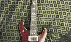 Schecter Model C/SH-12, 12 string guitar, in that deep red colour that was only produced in 2007. This particular guitar is difficult to find. It hasn't seen much use because I'm more of an acoustic player and use my acoustic 12 string much more.
It has