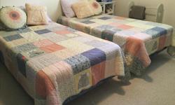 Reduced! Must go! Pair of twin beds on roller frames in excellent condition. Matching twin size quilts and cushions for extra $100.00