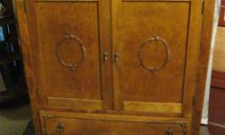 THIS 1920'S CHEST IS 34" WIDE, 20" DEEP AND 50" HIGH.
THERE ARE TWO HALF DRAWERS AT THE TOP.
THEN THERE ARE TWO DOORS COVERING 4 PULL OUT DRAWERS
BELOW THESE IS A FULL WIDTH DRAWER.
THERE IS DESIGN WORK ON THE DOORS AND DRAWERS.
ALL THE DRAWERS ARE