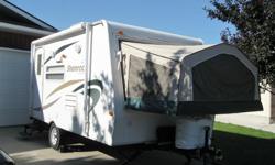 Hybrid travel trailer with air conditioner, queen fold down bed at each end. The canvas is all intact and the windows and vents have recently been re-caulked. Has excellent washroom facilties with stand up and outdoor showers. The unit is wired for TV and
