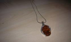 this is silver and comes with a lovely stone callled amber. The neckless alone was 150.00, i have a matching bracelette to it. Worn once and laying around. You could even use it as a gift, you can't tell its used.