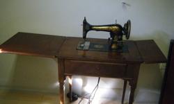 Old Singer Sewing Machine in cabinet. Working condition. Nice cabinet.