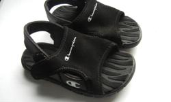 black, like new, slips on by opening the top of the sandal, then velcro it closed.