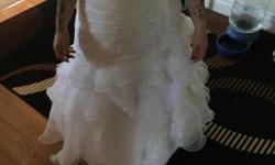 Size 8 wedding dress
Hemmed to about 5 feet maybe a bit more
There is a train to it, just bustled in the picture
Corset back
Lots of beading through out