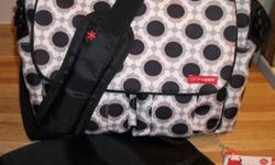 Skip Hop brand diaper bag, Dash Deluxe model in Blossom pattern.  In excellent lightly used condition.  Purchased new 6 months ago from Dear-Born baby in Toronto for $79 plus tax, I am asking $35.  Straps attach easily to any stroller handles.  Please