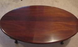 One oval solid mahogany coffee table in excellent condition