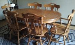 Beautiful solid oak dining room table, excellent condition, 2 captains chairs and 4 straight back, honey in color,comes with 2 leaves to extend to fit 10 to 12 places, paid over $4000 for it and selling for $1800.00 or best offer. Please send email for