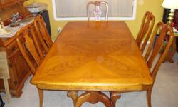 Oak table, in excellent condition. 42" X 72" that extends to 84" with a 12" leaf. Six matching chairs with upholstered fabric seats, two of which are captains chairs.
