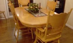 Honey finish, solid oak dining room table. Great Condition! Claw foot centre pedestal with! 2 press back arm chairs, 2 press back side chairs and 1 extension leaf. We just put down new flooring and table doesn't match. Smoke free home - $500.00 or B.O.