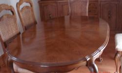 This dinning table is 64x47 and extends to 100". This table extends to 100" by two 18" leafs. It is in very good condition. Moving must sell. We are moving. It is solid oak. It has 4 side chairs and 2 arm chairs.  This is a very nice piece of furniture