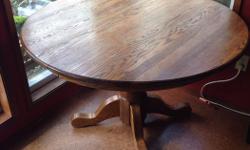 Beautiful pedestal solid oak dinning table with an addition leaf. Can fit up to 8 people. Good condition. Non smoking home.