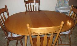 Solid wood dining table comes with four high back chairs and 1 leaf. $100 Call 250 545-5495