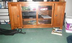 Solid wood TV stand
No Scratches on it
Great Condition
DVD Rack on the sides
Three shelving space in centre with glass doors
 
Please contact me via EMAIL if you are interested as I am barely ever home. mailto:laetacia.beaudoin@hotmail.com
 
Thank you.