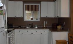 Pictures shown are finished first then before below.
If your kitchen cabinets aren't looking so great, and you want to change that oak, melamine or wood how about a face lift of refinishing, staining, spray painting or lacquer to your kitchen doors and