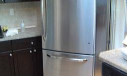Brand new, never used stainless steel GE fridge with bottom freezer. Must sell. 800.00 OBO. Selling because it came with the home we purchased and we already have a fridge. 30 W x 32 D x 65.5 H