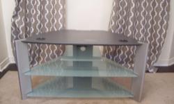 I have a large silver and frosted glass tv stand for sale. In MINT condition. Dimensions are 40" wide x 21" deep x 21" high. Asking 50$firm Able to deliver for a fee. Serious buyers only