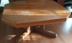 Low coffee table with solid teak legs. Top needs refinishing.