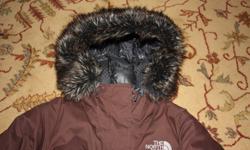 Women's brown North Face jacket size medium.  In excellent condition and very, very warm.  Has fuzzy hood, inside pockets and a belt to trap the heat in.  Paid over $400.
