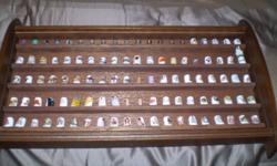 QUITE ATTRACTIVE THIMBLE COLLECTION OF 97 IN WOODEN CASE. MOST OF THE THIMBLES ARE BONE CHINA. MUST SEE.