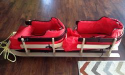 Fabulous wood construction toboggan for 2. Padded seats and boot covers on each seat. Originally purchased at Sears through the catalogue for over $200. In excellent condition.