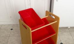 Toss your toys, craft supplies, tools, sewing stuff, or other knick knacks into this cute little shelf that holds 3 red plastic bins!