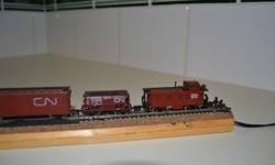 Trix "N" scale steam engine and 5 cars, plus a watertower.