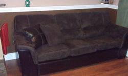 Almost new Ultra Suede and Faux Leather Couch. approx. 3 years old. Chocolate brown and Dark Brown in color. Seat cushions are removable. Comes with 2 matching pillows. Contact if you would like to see it!