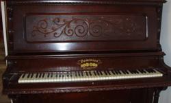 Upright grand piano, made by the Dominion Organ & Piano Company Inc, of Bowmanville, Ontario. Over 100 years old, ivory keys.