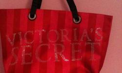 Victoria's Secret Tote, light pink with dark pink striping, black shoulder strap. Never been used. From a non-smoking home. May be able to arrange for delivery of this item.
