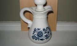 Nice white milk glass decanter with blue cobalt floral designs.Stands 6" in height.
 Dutch design.Has two very minor chips on pouring spout.Comes with orginal
  top.A nice piece.