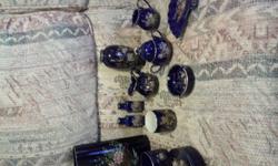 very nice vintage cobalt blue pottery set.
most pieces are cobalt blue peacock, 2 are pheasants, 1 is a scenery cart in a garden and 3 pieces are old fashioned pull cart with flowers. all cobalt blue with gold trim. asking $20 for all