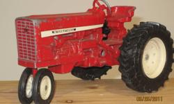 Vintage International Tractor - 1/16 scale, diecast metal, Made In The U.S.A by The Ertl Company in Dyersville, Iowa. Tractor is in very good condition, it has normal wear from play.