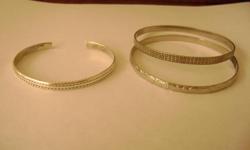 Vintage Sterling Silver Bracelet
 
Stamp: .925 for sterling
From the 1970's
It is the bracelet on the left in the photo
Measures 7 1/2 inches around
$15.00
 
The two bracelets on the right in the photo are also from the 1970's - some type of vintage