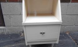 Night stand made of solid wood (not veneered) is in great solid sturdy condition . Classic mid century modern design with tapered legs and gorgeous vintage drawer pull. Shabby chic ivory colour, but you could easily repaint it to suit your decor. Drawer