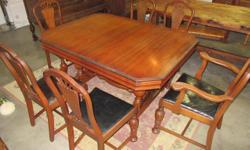 Walnut dining table with 6 chairs. Fold out leaf. Minor wear to table, a little more wear to the chairs, but still solid. Believe the leather seats are original. Measures 66" X 42", and extends to 71 1/2" with leaf up. Top of the chair backs are 38 1/2"