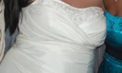 i am selling my wedding dress which was worn only the one day! im asking $300 OBO, its ivroy and size 20, with a corset back so it can go up and down a size or to, im size 14 in street clothes as wedding dresses fit small! you are more then welcome to