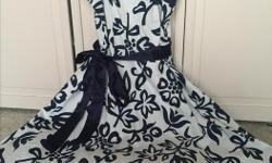 Cute and fun white and navy print dress with sash and full crinoline. B. Smart size 5/6-worn only once and in excellent condition. Call Nicki at 250-361-6634
