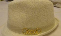 White hat with a gold detail on the side