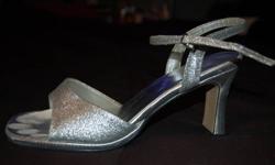 These heels are size 8 womens. They are sparkly silver and have a small heel. They are slightly worn but still in great shape!