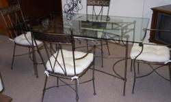 Wrought Iron Glass Dining Table - 4 Chairs with White cushions. 5' L x 3' W x 30" H NEW PRICE $219.00