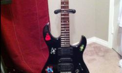 Jet black guitar with all black strings the stickers are removable and I will take them off if you want, great starter guitar, comes with an amp a guitar case 2 pics , and a tuner, sounds great, also comes with stand perfect guitar for anyone , 300 or