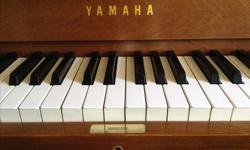 This Yamaha piano has been lovingly maintained in the same family since new. This professional series (P2) was meant with durability in mind for institutional school usage but fits perfectly into any home decor. Finished in satin walnut, the cabinet is